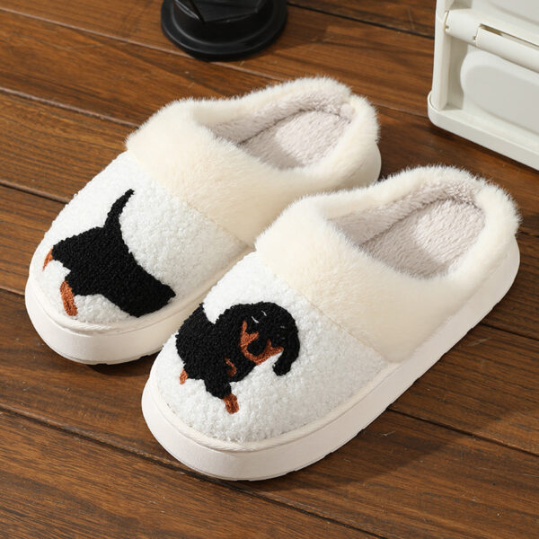 a pair of white slippers with a dog on it